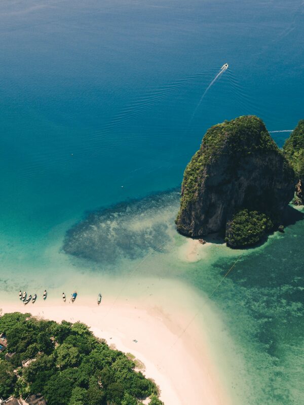 The limestone cliffs and beach at Railay in Krabi, where a Nannimoon nanny comes to your hotel or villa
